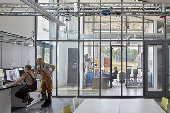 Photo of Chatham University faculty and students wearing waders, working in the aquaculture lab on the Eden Hall Campus. 